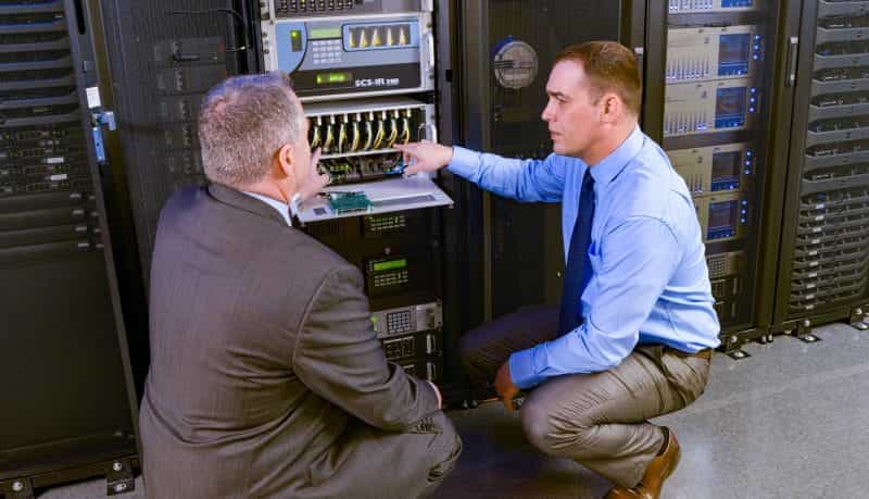 Two men discussing an electrical system.