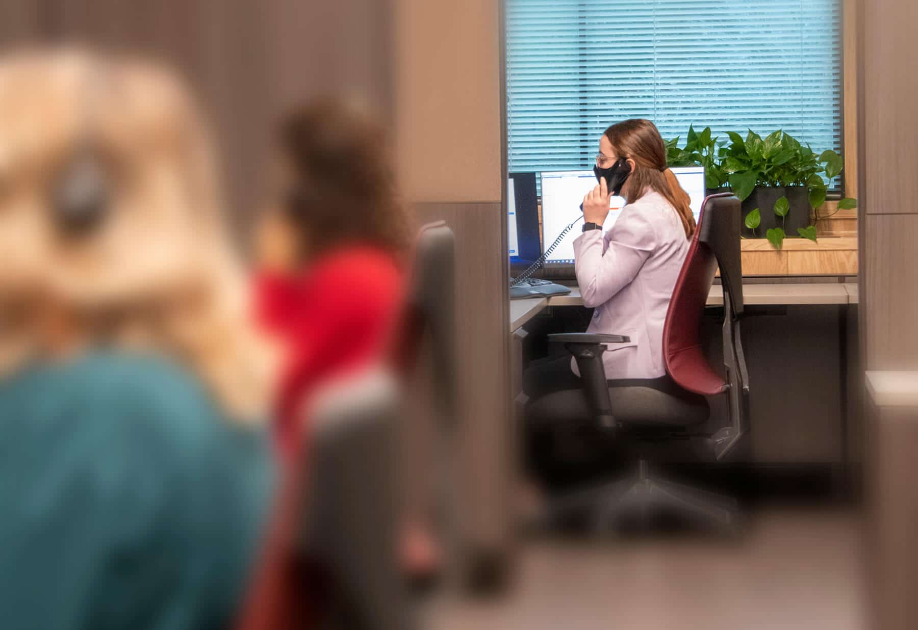 Worker talking on the phone in office.