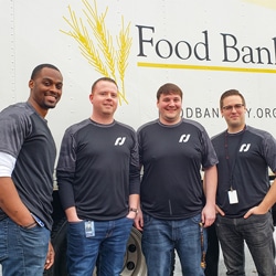 Group of people standing in front of food bank.
