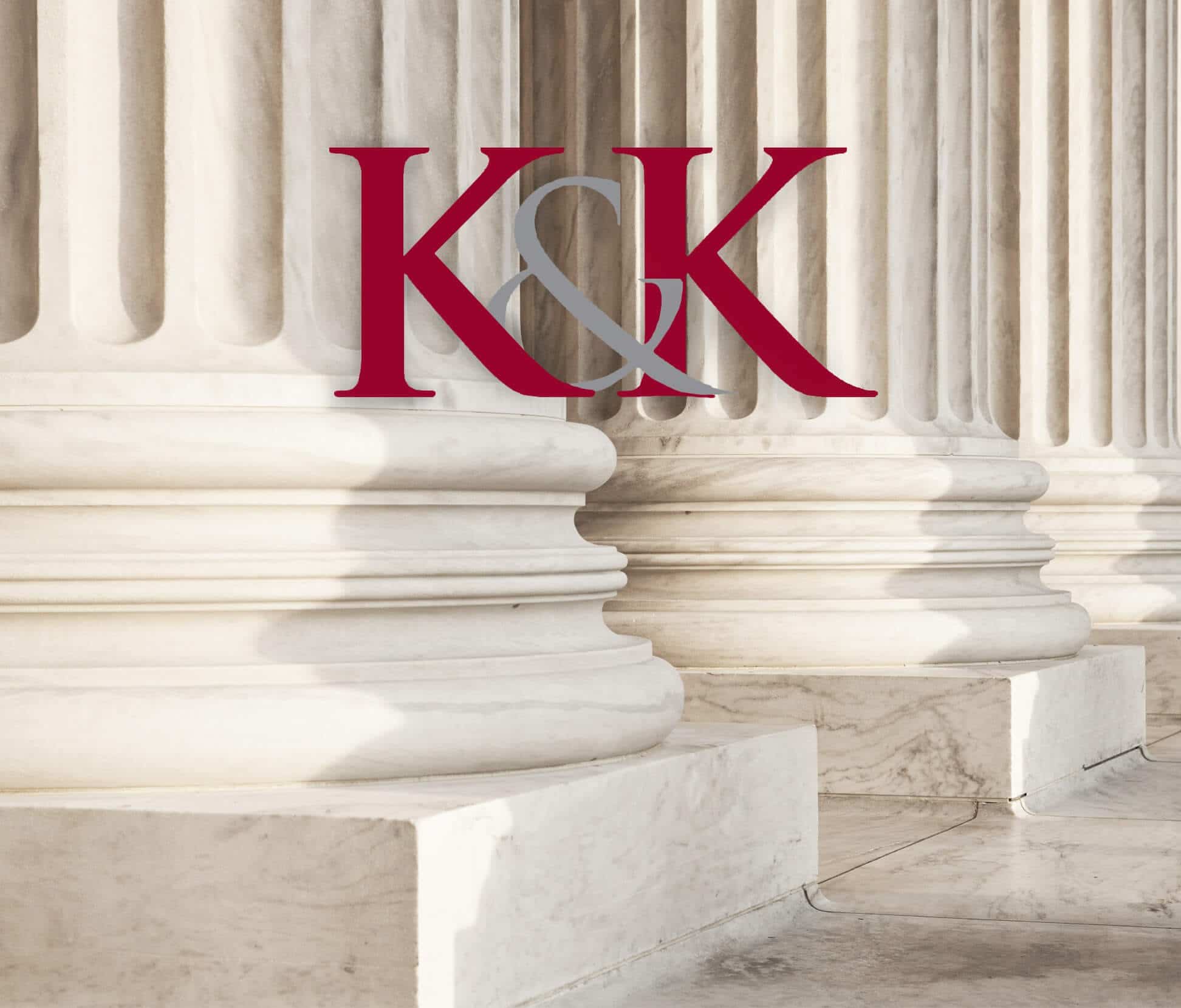 K&K in front of white pillars badge.