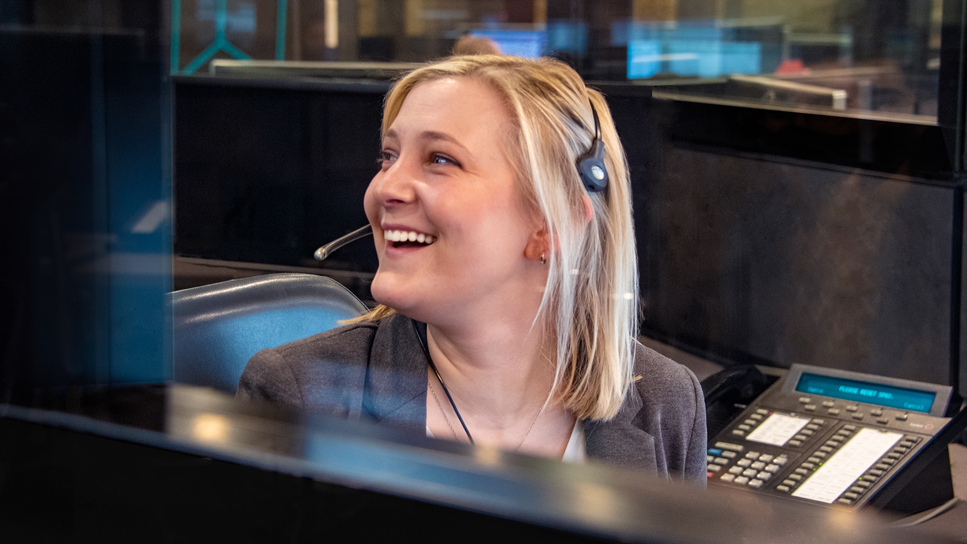 blonde lady smiling with headset on