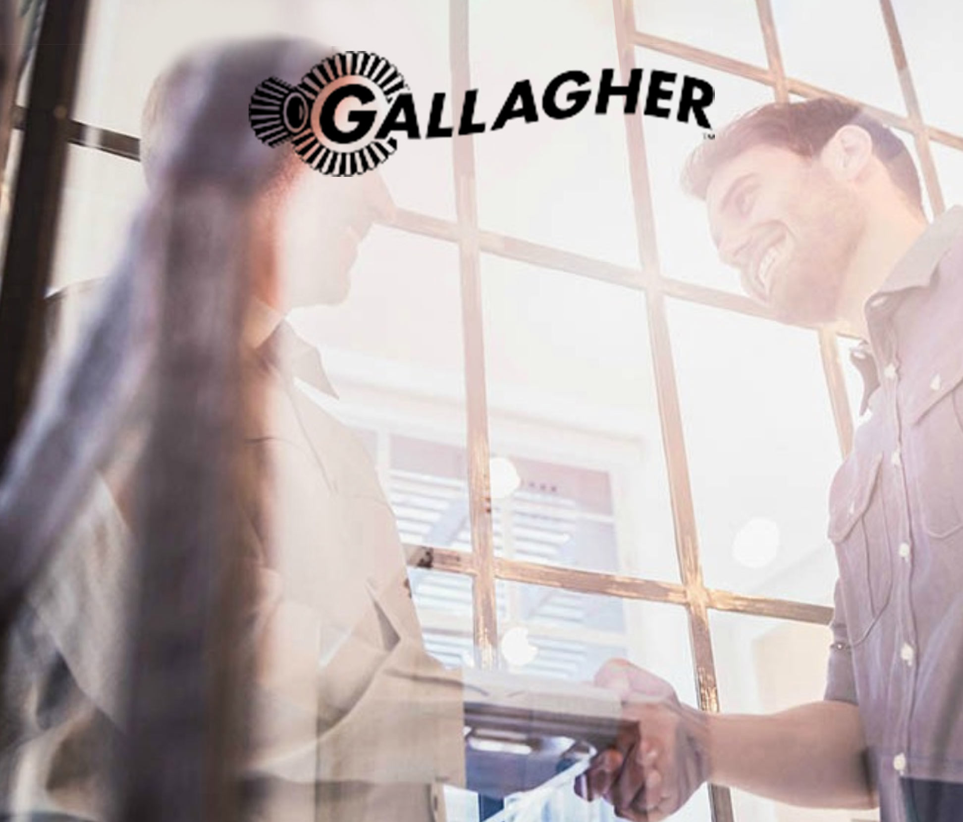 man and women talking with gallagher logo above
